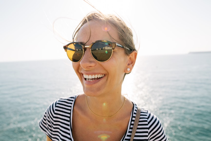 Woman in sunglasses overlooking the ocean